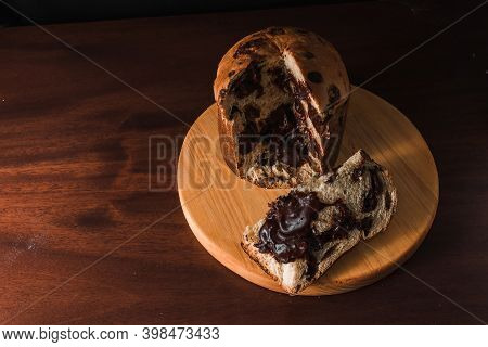 Chocolate Panettone Slice On Dark Background. Panettone Of Chocolate Known In Brazil As Chocottone.
