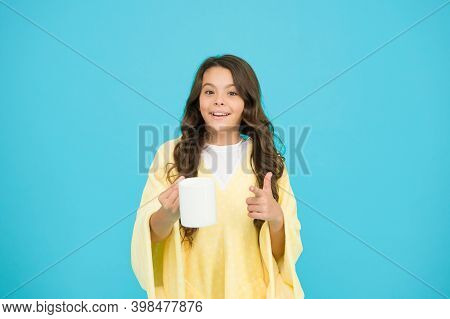 Kid Wearing Soft Poncho Drinking Tea. Little Girl With Long Hair. Feeling Comfy. Adorable Child On T