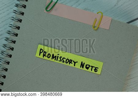 Promissory Note Write On Sticky Notes Isolated On Wooden Table.