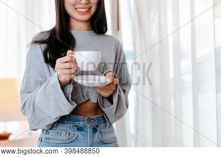 Woman Relxing Time While Working And Hold Cup Of Coffee At Working Place.