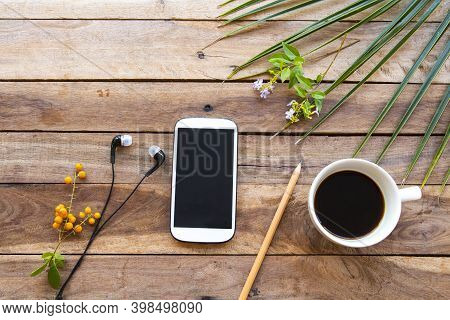 Mobile Phone ,hot Coffee Espresso With Leaves Arrangement Flay Lay Style On Background Wooden
