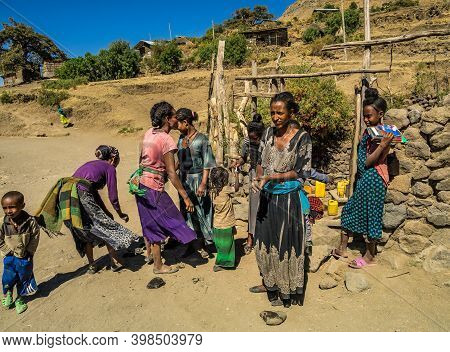 Lalibela, Ethiopia - Feb 14, 2020: People Getting Water At A Water Point In Lalibela, Ethiopia. Afri