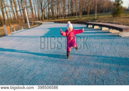 Little Girl Learning Roller Skating Tricks Ourside