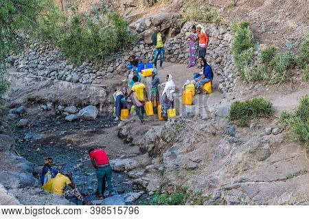 Lalibela, Ethiopia - Feb 12, 2020: People Getting Water At A Water Point In Lalibela, Ethiopia. Afri