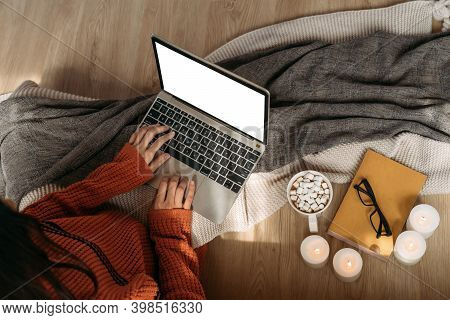 Top View Of Unrecognizable Woman Wearing A Knitted Sweater Using Laptop With Copy Space On The Scree