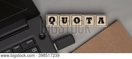 The Word Quota Made From Wooden Cubes. Conceptual Photo. Top View