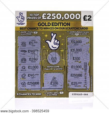 Swindon, Uk - December 5, 2020:  A Used National Lottery £250,000 Gold Edition Scratchcard On A Whit