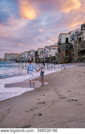 Couple On Vacation Sicily Visiting The Old Town Of Cefalu, Sunset At The Beach Of Cefalu Sicily, Old