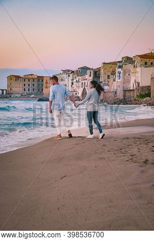 Couple On Vacation Sicily Visiting The Old Town Of Cefalu, Sunset At The Beach Of Cefalu Sicily, Old