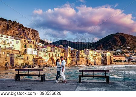 Couple On Vacation Sicily Visiting The Old Town Of Cefalu, Sunset At The Beach Of Cefalu Sicily, Old