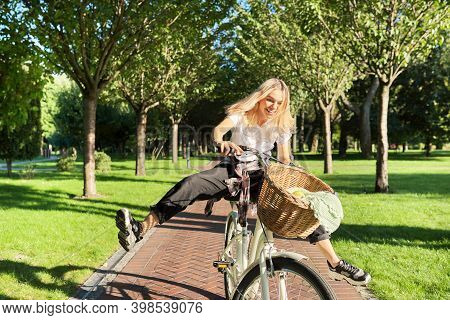 Happy Young Woman Riding Bike On Road In Park, Beautiful Hipter Teenager Having Fun And Laughing.