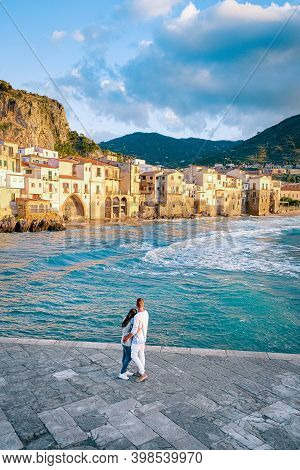 Couple On Vacation Sicily Visiting The Old Town Of Cefalu, Sunset At The Beach Of Cefalu Sicily, Old
