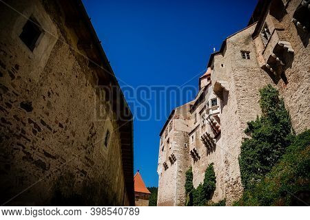 Gothic Imposing Historic Castle Pernstejn At Sunny Summer Day, Stronghold On Rock Above Village Of N