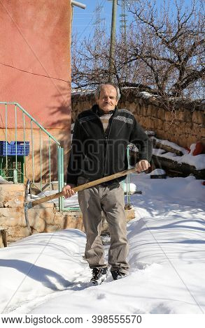 Nigde,turkey-january 15:unidentified Man Standing In Front Of His House With A Pickaxe.january 15,20