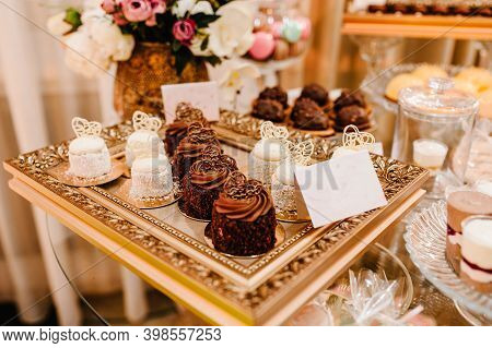 Table With Muffins, Cakes, Sweets, Candy, Buffet. Dessert Table For A Party Goodies For The Wedding 
