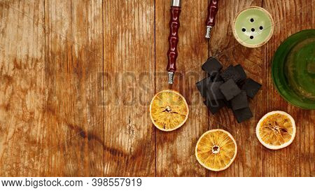 Coals For Hookah On Wooden Background With Dry Oranges And Bowl. Place For Text And Top View