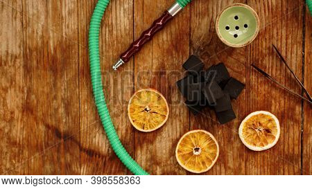 Coals For Hookah On Wooden Background With Dry Oranges And Bowl. Place For Text And Top View