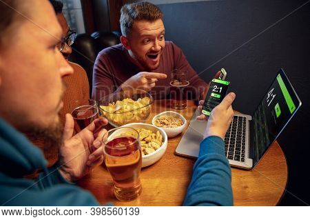 Emotions. Excited Fans In Bar With Beer And Mobile App For Betting, Score On Their Devices. Screen W