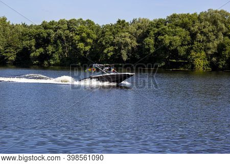 Modern Speedboat Sailing On Forest Background. Summer Leisure And Water Activity. Rest On The River 