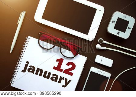 January 12nd. Day 12 Of Month, Calendar Date. Office Workplace With Laptop, Notebook, Office Supplie