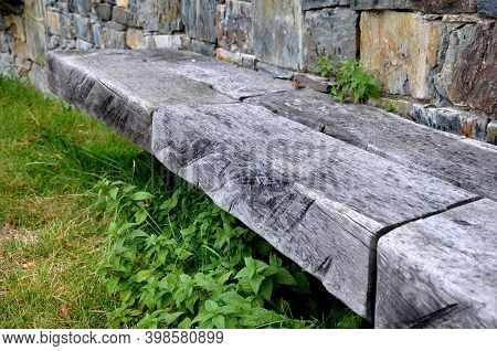 Gray Stone Wall With Solid Wood Bench Folded Without Cement And Concrete. Stone Quartzite Durable Re