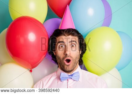 Portrait Of Shocked Man Open Mouth Wear Cone Cap Pink Shirt Purple Bow Isolated Many Balloons Creati