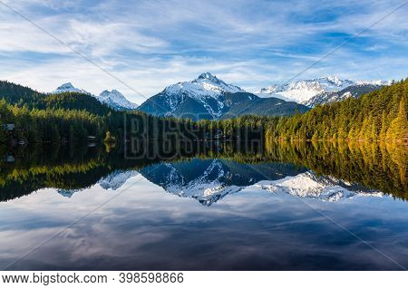 Beautiful Peaceful View Of Levette Lake With Famous Tantalus Mountain Range In The Background. Taken