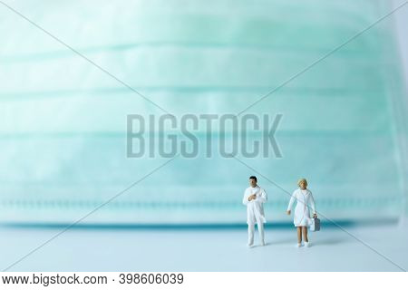 Healthcare Concept. Closeup Of Docter And Nurse Miniature Figure People Walking With Surgical Face M