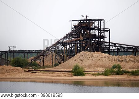 Huge Stationary Rusty Separator Of Sand And Gravel On The Shore Of The Reservoir