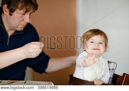 Father Feeding Baby Girl From Spoon Mashed Vegetables And Puree. Food, Child, Feeding And People Con