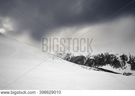 Snowy Ski Slope In High Mountains And Cloudy Storm Sky At Winter Before Blizzard. Ski Area Mottolino