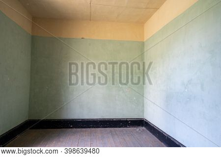 Interior Of An Empty Room In An Abandoned Building, Paint Colors Of Green, Yellow And Black
