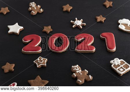 Inscription 2021 From Gingerbread Cookie. Christmas Bacing, Black Background.