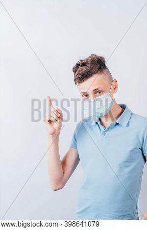 Insight. Important Information. Attention Gesture. Boy In Medical Mask Pointing Finger Over Backgrou