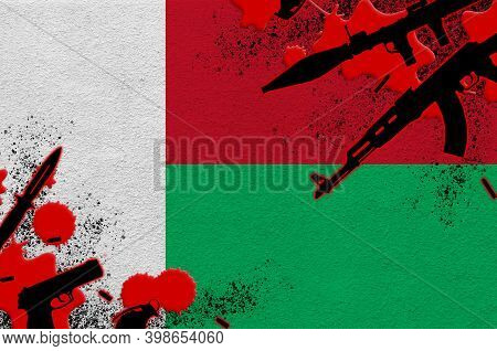 Madagascar Flag And Various Weapons In Red Blood. Concept For Terror Attack And Military Operations 