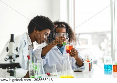Two African American Cute Little Boy And Girl Student Child Learning Research And Doing A Chemical E