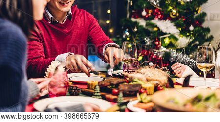 Portrait Of Happy Big Family Celebrating Santa Hats Having Fun And Lunch Together Enjoying Spending 