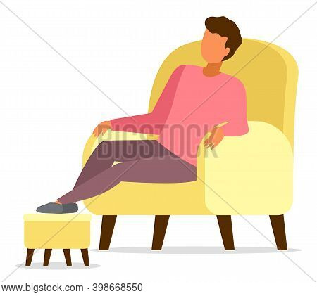 Man Sitting In Yellow Armchair Relaxing, Put His Feet On A Special Soft Padded Stool Stand, Comfort 