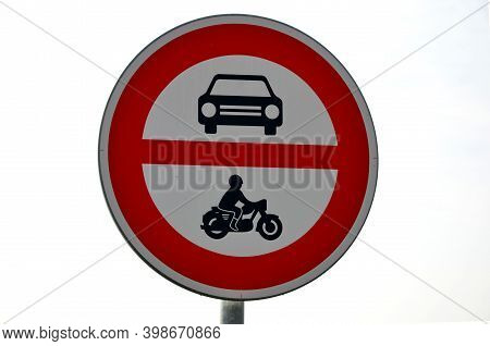 Road Sign No Entry Of All Motor Vehicles, Including Motorcycles Is Located In The Fields By The Road