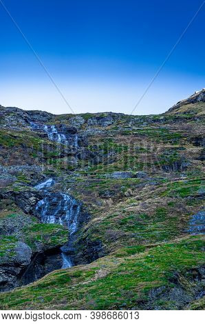Waterfall Free Falling From A Steep Mountain Slope.