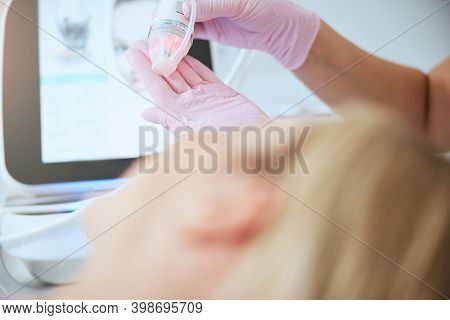 Female Doctor Preparing The Fractional Microneedle Machine For Work
