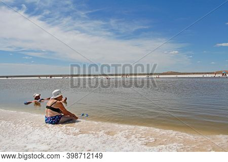 Baskunchak, Astrakhan Region, Russia - July 28, 2020: An Elderly Woman Sitting On The Edge Of Baskun