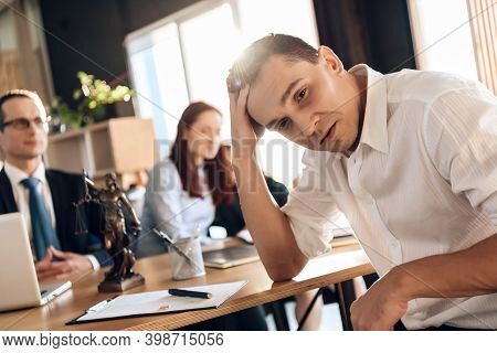 Frustrated Father In Suit Sits On Couch Next To Young Wife And Daughter. A Man Sits In A Suit And Lo