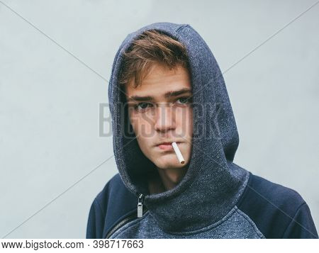 The Teenager Smokes A Cigarette, Addicted Nicotine Problems In Young Age.