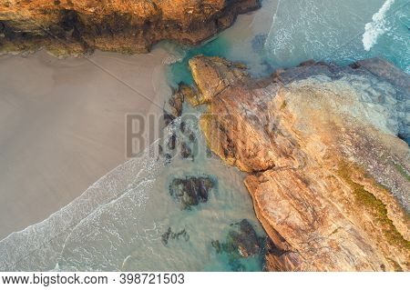 Rocky Sea Coast At Sunrise. Beach Playa De Las Catedrales In Ribadeo, Spain, Europe. Aerial View