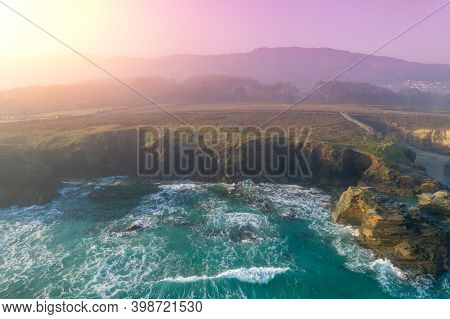 Rocky Sea Coast At Sunrise. Beach Playa De Las Catedrales In Ribadeo, Spain, Europe. Aerial View