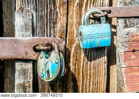 Lock And Forged Curtain On A Wooden Door