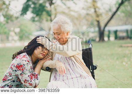 Help And Care Asian Senior Or Elderly Old Lady Woman Patient Sitting On Wheelchair At Park In Nursin