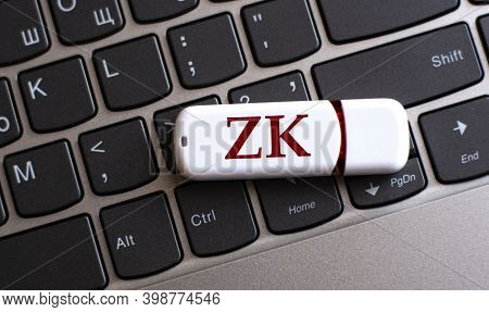 Zk - The Word On A White Flash Drive, Lying On A Black Laptop Keyboard