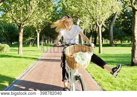 Happy Young Woman Riding Bike On Road In Park, Beautiful Hipter Teenager Having Fun And Laughing.